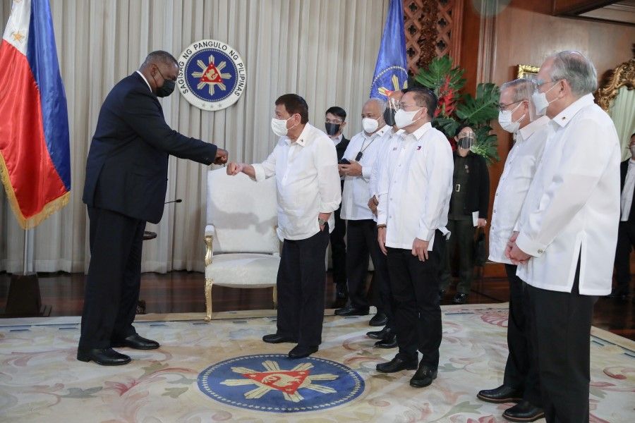 US Secretary of Defence Lloyd Austin fist bumps with Philippine President Rodrigo Duterte during a courtesy call at the Malacanang Palace in Manila, Philippines, 29 July 2021. (Robinson Ninal/Malacanang Presidential Photographers Division/Handout via Reuters)