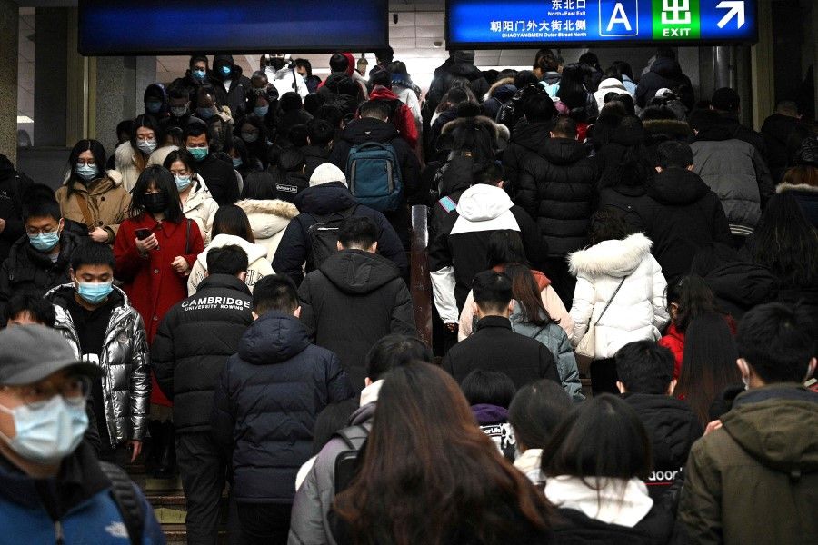 People walk at a subway station during the morning rush hour in Beijing, China, on 6 January 2022. (Noel Celis/AFP)