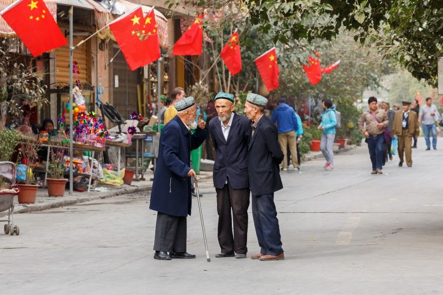 Three elderly men of the Uyghur minority having a conversation on a street in Kashgar Old Town, 4 October 2017. (iStock)