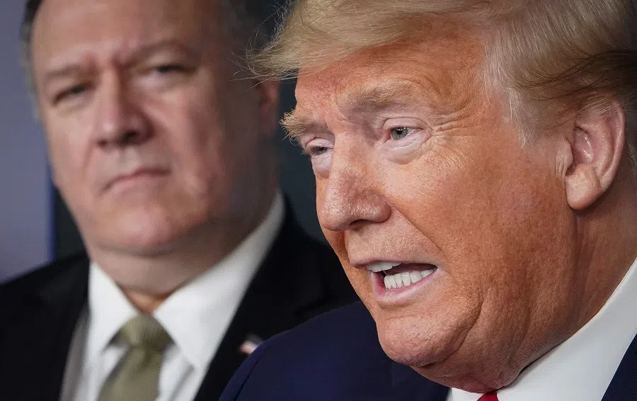 In this file photo, then-US Secretary of State Mike Pompeo listens as then-US President Donald Trump speaks during the daily briefing on Covid-19 coronavirus, in the Brady Briefing Room at the White House on 8 April 2020, in Washington, DC. (Mandel Ngan/AFP)