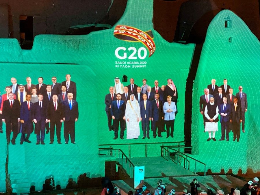 "Family Photo" for annual G20 Summit World Leaders is projected onto Salwa Palace in At-Turaif, one of Saudi Arabia?s UNESCO World Heritage sites, in Diriyah, Saudi Arabia, 20 November 2020. (Nael Shyoukhi/REUTERS)