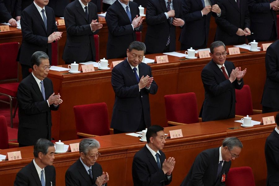 Chinese President Xi Jinping and other leaders applaud at the end of the closing session of the Chinese People’s Political Consultative Conference (CPPCC) at the Great Hall of the People in Beijing, China, on 10 March 2024.  (Florence Lo/Reuters)