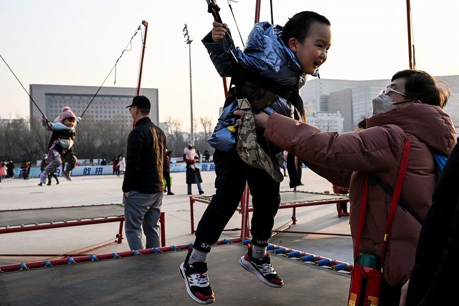 Children jump on trampolines at a mall in Beijing, China, on 5 February 2023. (Noel Celis/AFP)