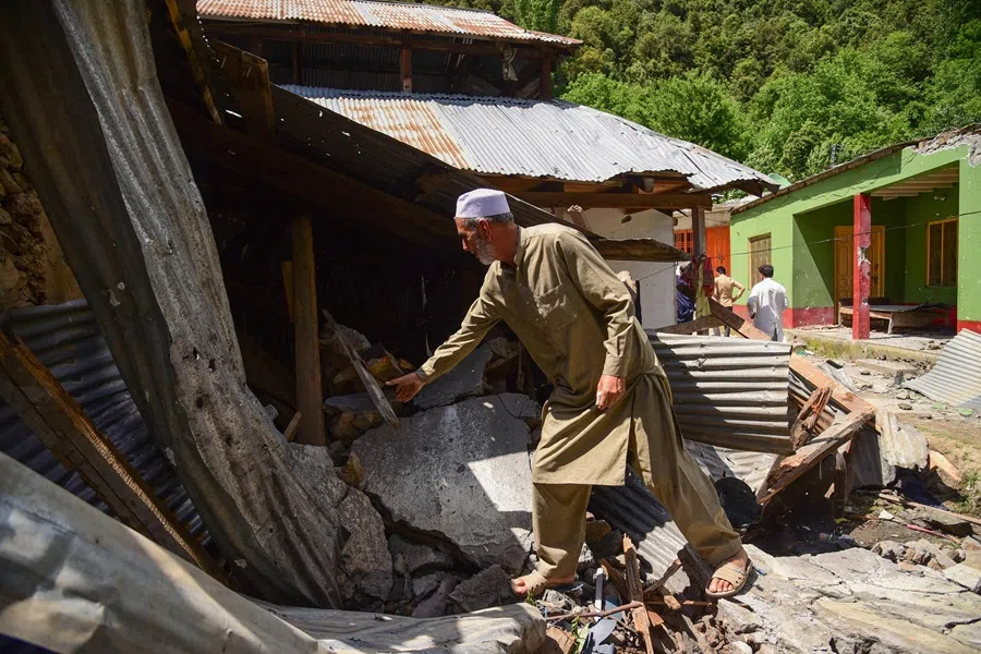 A resident inspects his damaged house after cross-border shelling along the Line of Control between Pakistan and India, in the Shahkot sector in Neelum Valley of Pakistan-administered Kashmir on 12 May 2025. (Muzammil Ahmed/AFP)