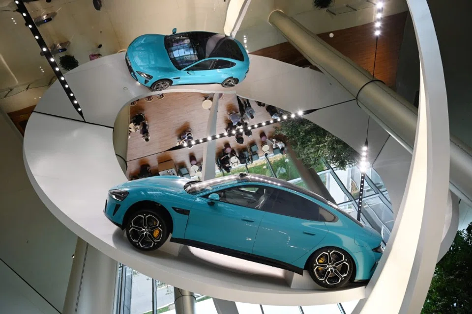 A Xiaomi SU7 Max car is displayed at the entrance to the Xiaomi EV Factory in Beijing on 1 July 2025. (Greg Baker/AFP)