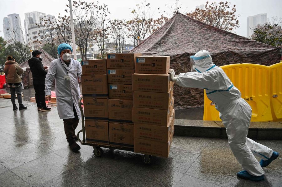 Medical staff transport supplies at the Wuhan Red Cross Hospital in Wuhan on 24 January 2020. (Hector Retamal/AFP)