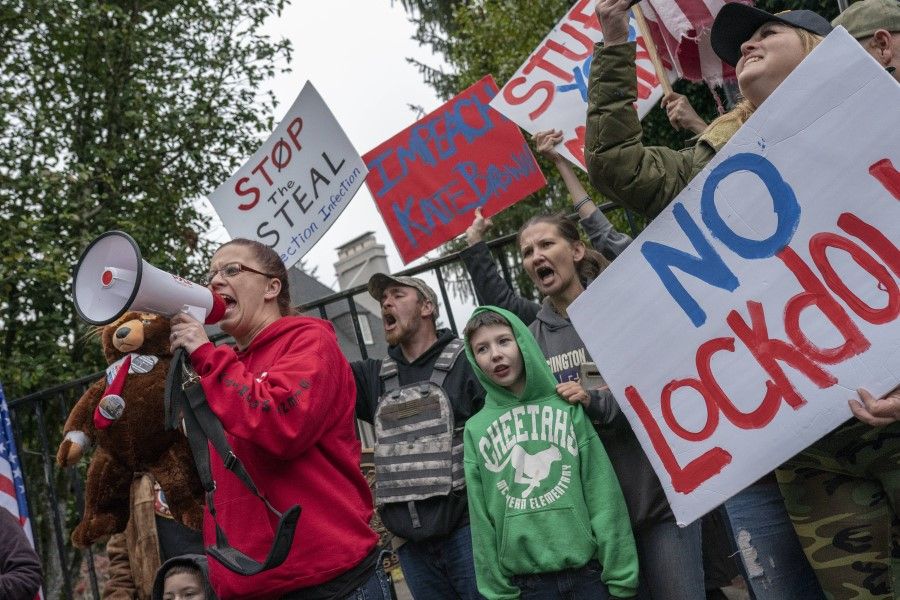 Protesters rally in front of Gov. Kate Brown's residence, Mahonia Hall, on 21 November 2020 in Salem, Oregon. Protesters angered by lockdown measures and the presidential election results rallied for the third consecutive weekend in the state's capitol. (Nathan Howard/AFP)