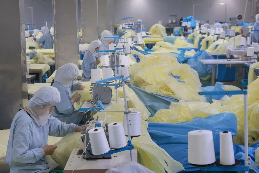Workers produce medical supplies that will be exported at a factory in Nantong, Jiangsu province, China on 3 August 2023. (AFP)