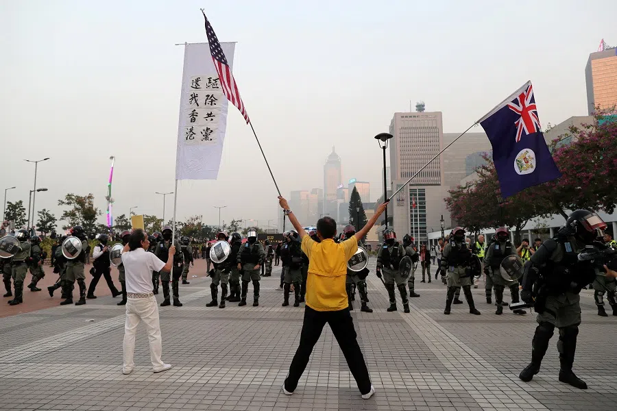 Hong Kong protesters face off against riot police at a rally in support of the human rights of Xinjiang Uighurs in Hong Kong, China, 22 December 2019. (Lucy Nicholson/Reuters)