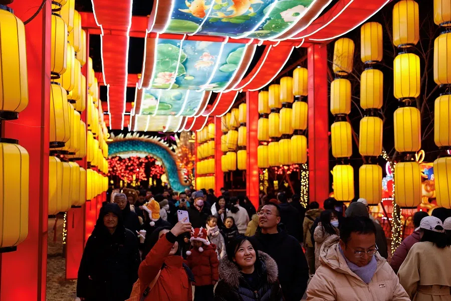 People enjoy light installations at a park in Beijing, China, on 24 February 2024. (Tingshu Wang/Reuters)