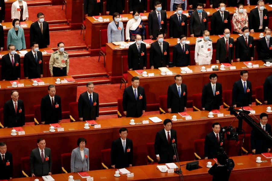 Chinese President Xi Jinping and other officials, some wearing face masks following the coronavirus disease (COVID-19) outbreak, attend the closing session of the National People's Congress (NPC) at the Great Hall of the People in Beijing, 28 May 2020. (Carlos Garcia Rawlins/REUTERS)
