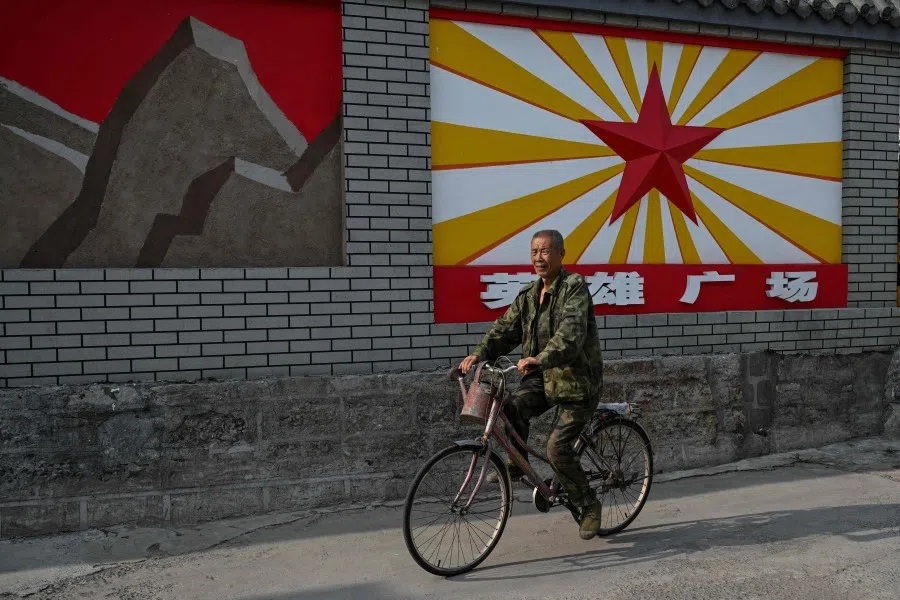 This photo taken on 23 July 2025 shows a man riding a bicycle past the site of the Mohetan Battle which took place in what China calls the Chinese People’s War of Resistance Against Japanese Aggression in Niangziguan, in China’s northern Shanxi province. (Hector Retamal/AFP)