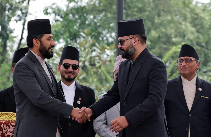 Newly appointed Prime Minister Balendra Shah, popularly known as "Balen", shakes hand with Rabi Lamichhane, president of Rastriya Swatantra Party (RSP) after taking the oath of office at "Shital Niwas", the presidential building in Kathmandu, Nepal, on 27 March 2026. (Navesh Chitrakar/Reuters)