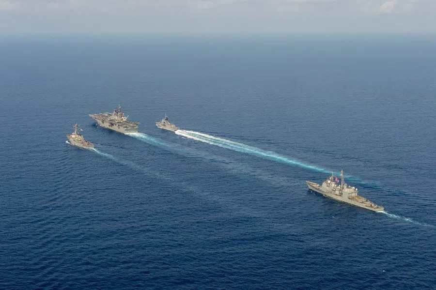 (L-R) Royal Australian Navy helicopter frigate HMAS Parramatta (top right) conducts officer of the watch manoeuvres with amphibious assault ship USS America (top middle), guided-missile destroyer USS Barry (top left) and guided-missile cruiser USS Bunker Hill (right) in the South China Sea, in this 18 April 2020 handout photo. (Australia Department Of Defence/Handout via REUTERS)