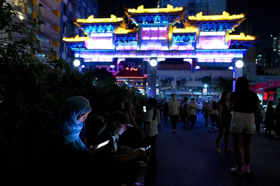 People stroll in the Chinatown section of Manila on 9 February 2024, on the eve of the Lunar New Year of the Dragon. (Jam Sta Rosa/AFP)