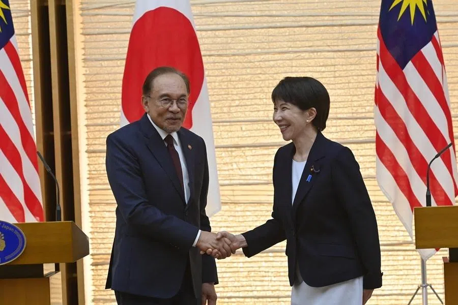 Japan's Prime Minister Sanae Takaichi (right) and Malaysian Prime Minister Anwar Ibrahim shake hands at the end of a joint press announcement following their bilateral meeting at the Prime Minister’s Office in Tokyo on 10 June 2026.