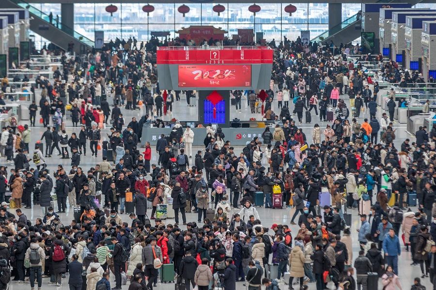 People line up to board trains at Zhengzhou, in China's central Henan Province on 26 January 2024, the first day of the annual Lunar New Year travel period. (AFP)