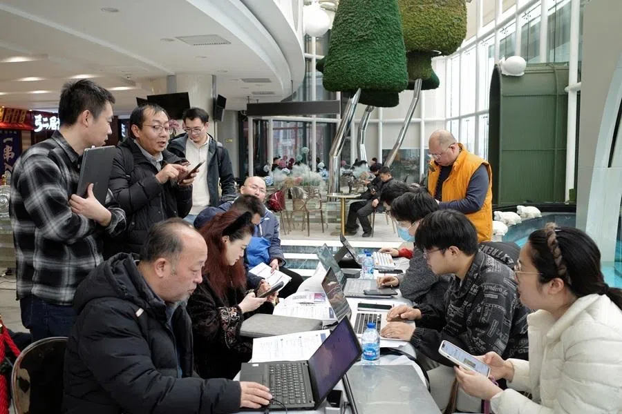 Zhipu staff members help residents install and setup AutoClaw, a local version of the AI agent OpenClaw developed by Zhipu, at an office building in Beijing, China, on 13 March 2026.