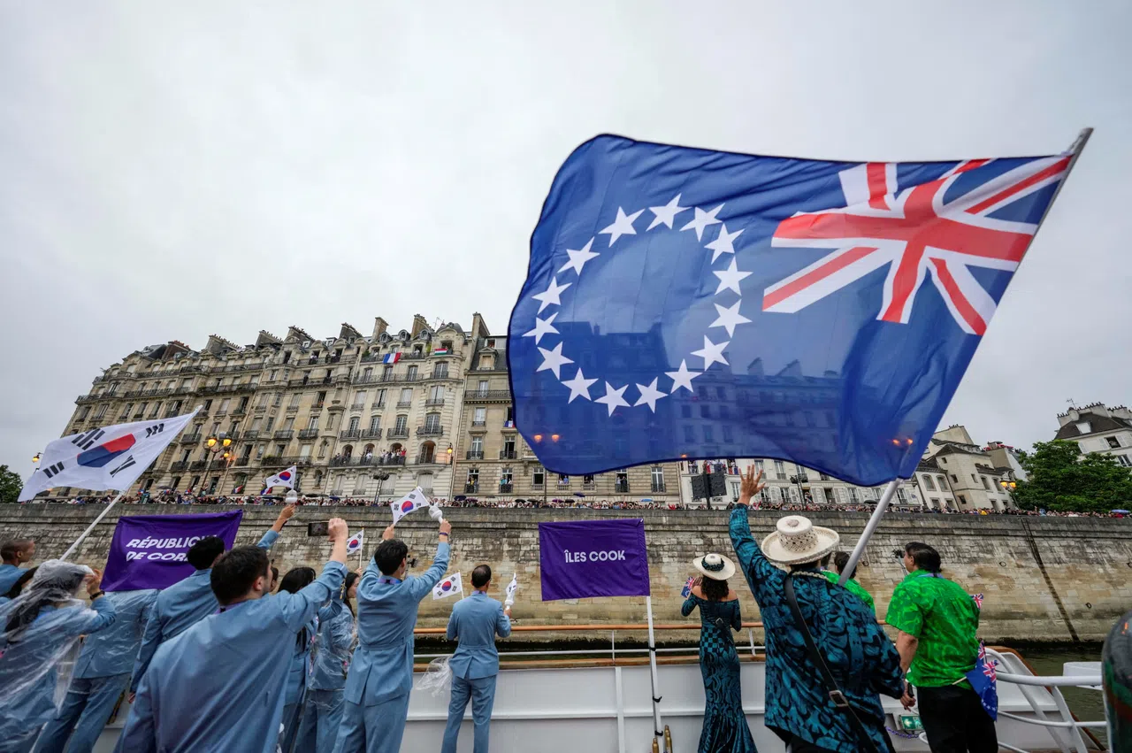 The Cook Islands flag being waved by the nation’s Olympic team from a boat during the opening ceremony of the 2024 Summer Olympics in Paris.