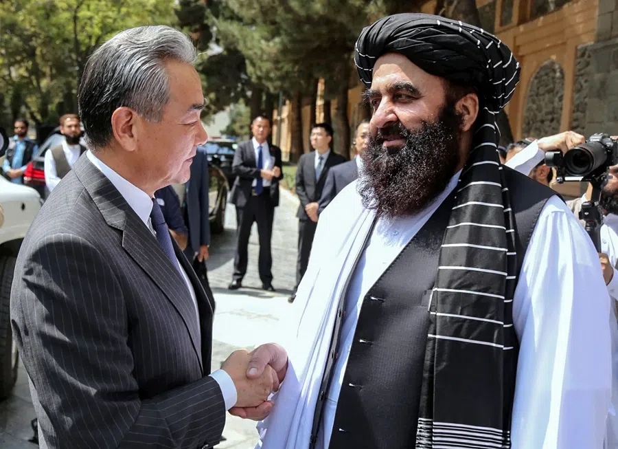 This handout photograph taken on 20 August 2025 and released by Afghanistan’s Ministry of Foreign Affairs shows Afghanistan’s Foreign Minister Amir Khan Muttaqi welcoming China’s Foreign Minister Wang Yi before their meeting in Kabul. (Afghanistan’s Ministry of Foreign Affairs/AFP)