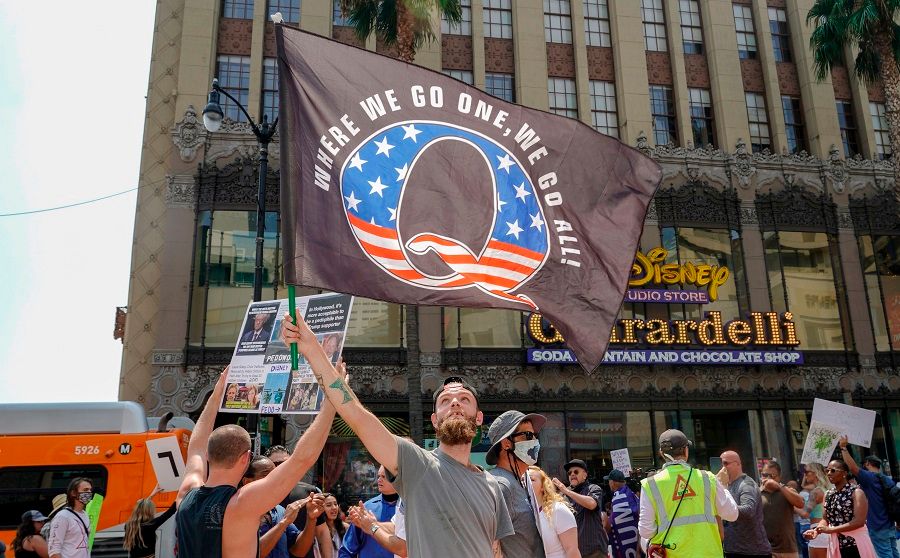 In this file photo taken on 22 August 2020, conspiracy theorist QAnon demonstrators protest child trafficking, on Hollywood Boulevard in Los Angeles. (Kyle Grillot/AFP)
