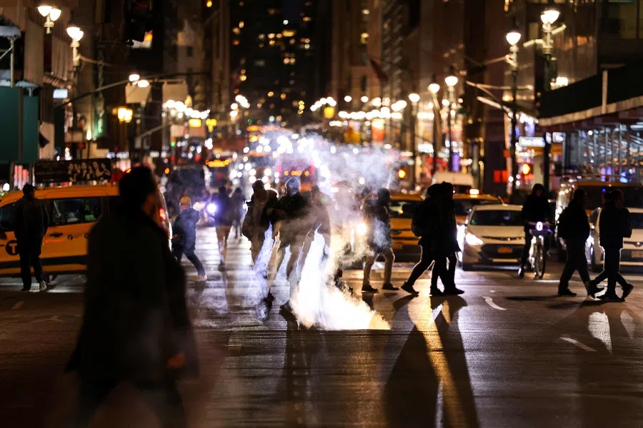 People cross the Madison avenue in the Manhattan borough of New York on 21 February 2024. (Charly Triballeau/AFP)