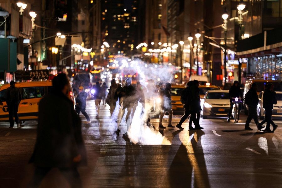 People cross the Madison Avenue in the Manhattan borough of New York on 21 February 2024. (Charly Triballeau/AFP)