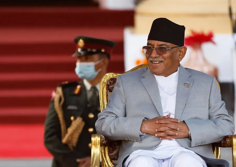 Leader of Maoist Centre and Nepal's newly elected prime minister Prachanda, smiles as he sits on a chair after administering the oath of office at the presidential building "Shital Niwas" in Kathmandu, Nepal, 26 December 2022. (Navesh Chitrakar/Reuters)