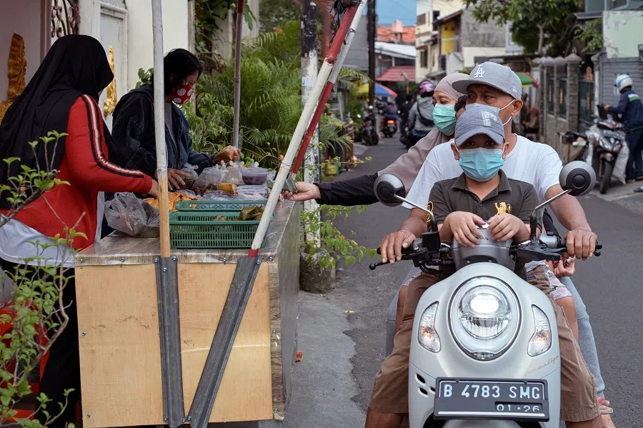 People purchase food and sweets to break their fast during the Islamic holy month of Ramadan in Jakarta, Indonesia, on 7 April 2022. (Bay Ismoyo/AFP)