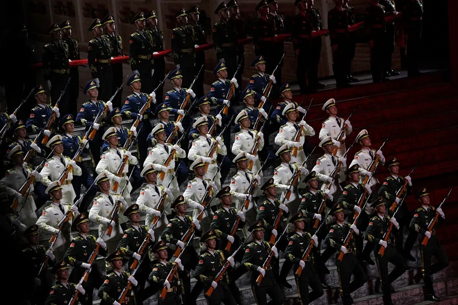 Honour guard members march onstage as they perform in an evening gala at the Great Hall of the People in Beijing, China on 3 September 2025. (Florence Lo/Reuters)