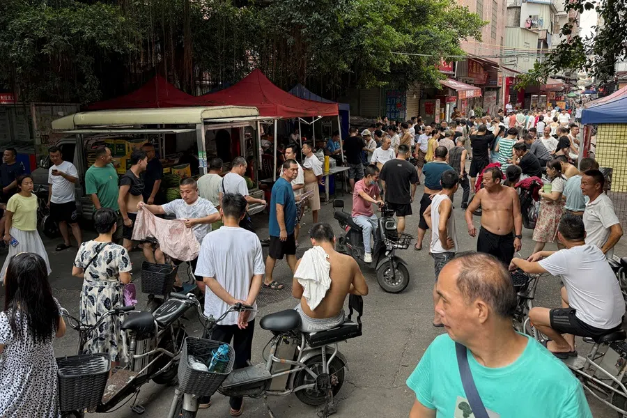 People crowd a street at Datang village in Guangzhou, Guangdong province, China, on 27 July 2025.  (David Kirton/Reuters)