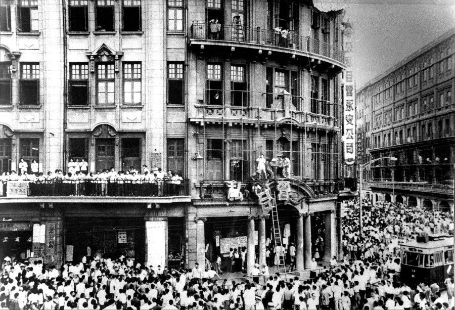 In 1966, the Cultural Revolution began in China, and leftist crowds demolished the signs of a department store on Nanjing Road in Shanghai.