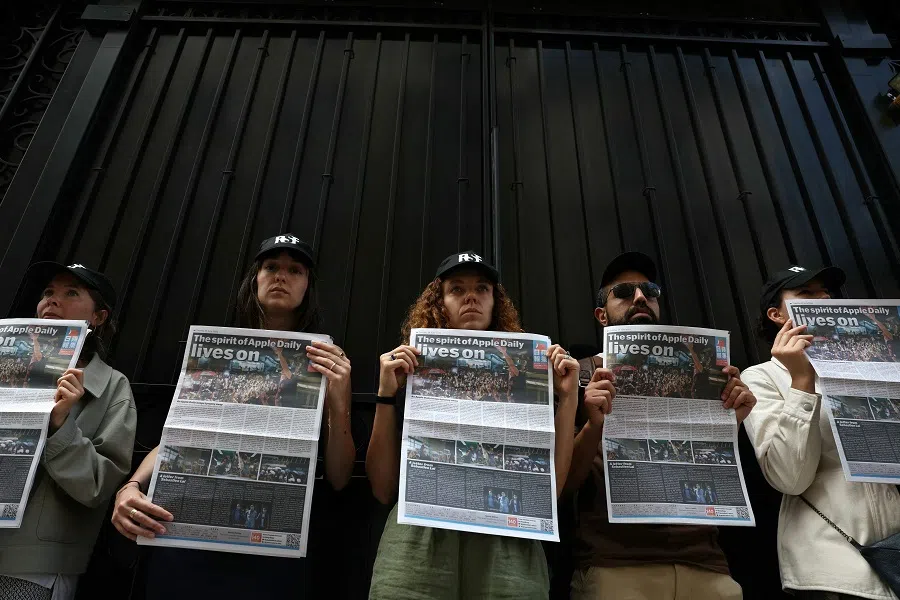 Activists of the international NGO Reporters sans frontieres (Reporters without borders) hold a special issue of now-shuttered Apple Daily, a pro-democracy newspaper and one of the largest Chinese-language media outlets in Hong Kong, to mark four years since its closure in front of the Chinese embassy in Paris on 23 June 2025. (Thomas Samson/AFP)