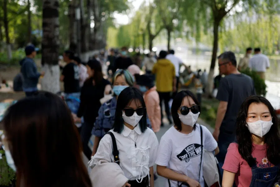 People in the Chaoyang district of Beijing, China, 2 May 2022. (Carlos Garcia Rawlins/Reuters)