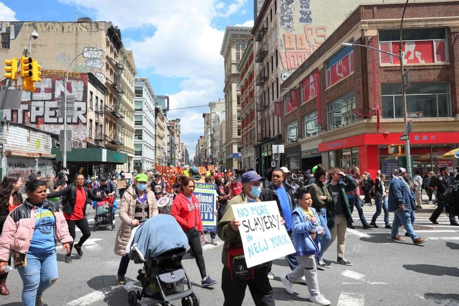 People march as they participate in a May Day rally on 1 May 2023 in New York City. (Michael M. Santiago/Getty Images via AFP)