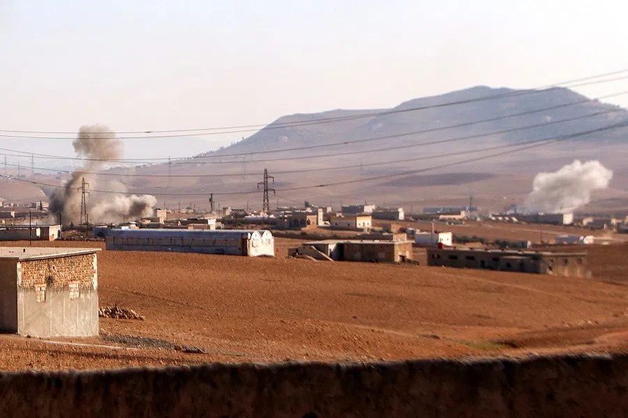 Plumes of smoke erupt from bombardment amidst ongoing battles between the Turkish-backed Syrian National Army faction and the Kurdish-led Syrian Democratic Forces (SDF) at a position near the Tishrin Dam in the vicinity of Manbij, in the east of Syria’s northern Aleppo province, on 10 January 2025. (Aaref Watad/AFP)