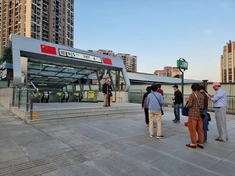 People take photographs outside the Hongyancun Station. (Photo: Edwin Ong)