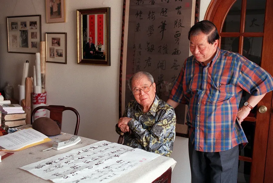 Pan Shou at home with his calligraphic works and with his son Pan Soo Yeng. (SPH Media)