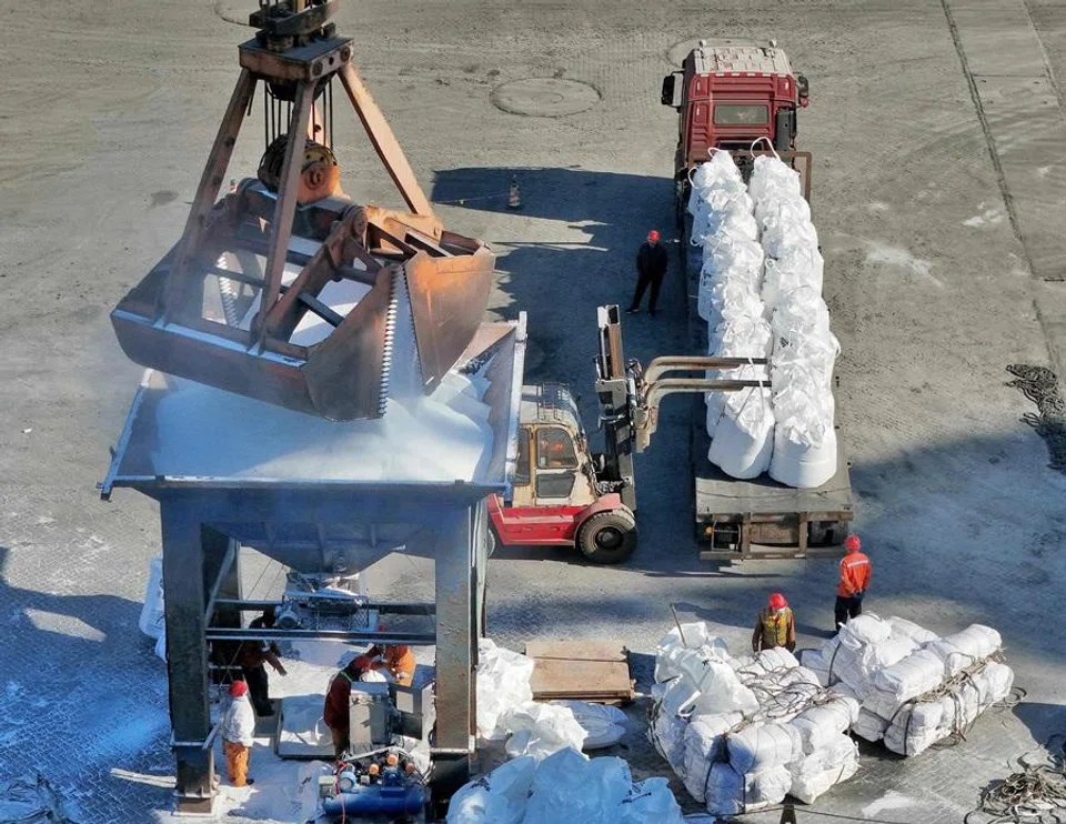 Fertiliser is unloaded from a ship at the port in Lianyungang, in China’s eastern Jiangsu province on 7 April 2026. (CN-STR/AFP)