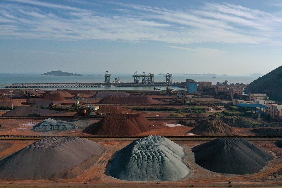 Piles of imported iron ore are seen at a port in Zhoushan, Zhejiang province, China, 9 May 2019. (Stringer/Reuters)