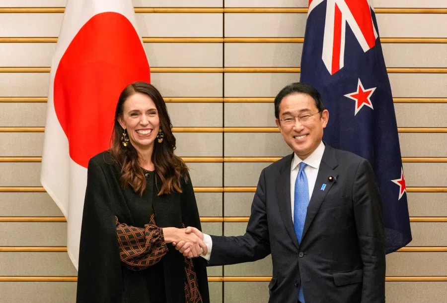 Japanese Prime Minister Fumio Kishida and New Zealand Prime Minister Jacinda Ardern shake hands at the start of the talks at the Prime Minister's official residence in Tokyo, Japan, 21 April 2022. (Kimimasa Mayama/Pool via Reuters)