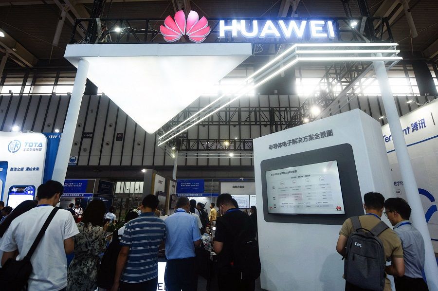People visit a Huawei booth during the World Semiconductor Congress in Nanjing, Jiangsu province, China, on 19 July 2023. (AFP)