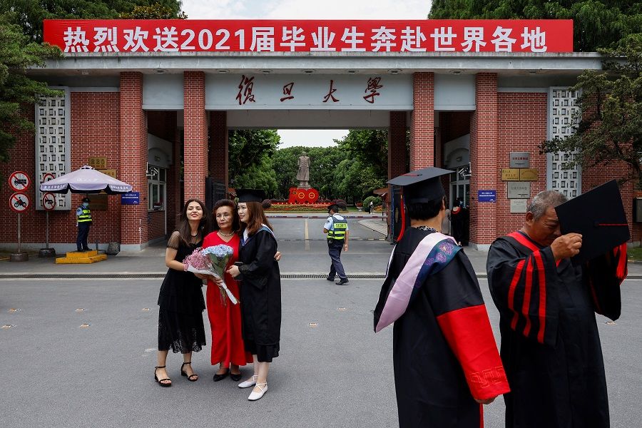Students take graduation photos at Fudan University in Shanghai, China, 25 June 2021. (Aly Song/Reuters)