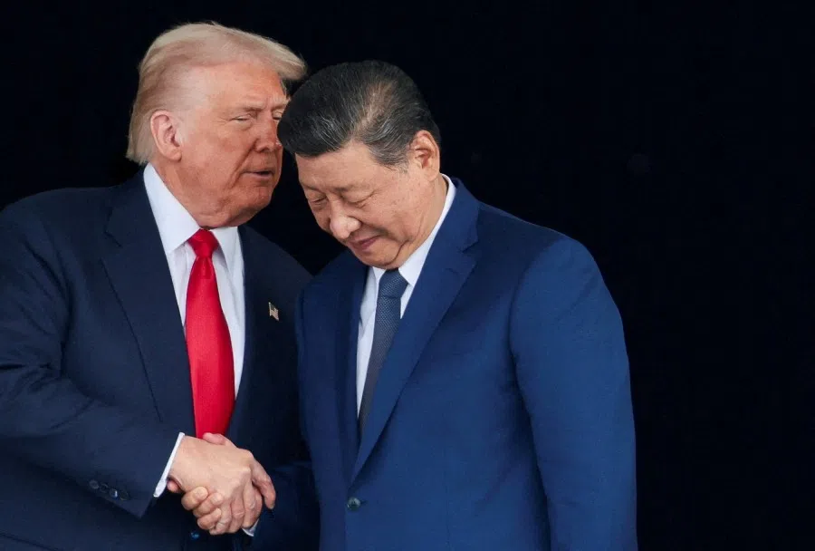 US President Donald Trump and Chinese President Xi Jinping talk as they leave after a bilateral meeting at Gimhae International Airport, on the sidelines of the Asia-Pacific Economic Cooperation (APEC) summit, in Busan, South Korea, 30 October 2025.