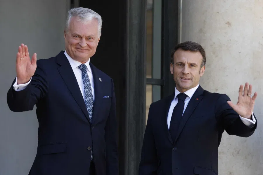 France's President Emmanuel Macron (right) welcomes Lithuania's President Gitanas Nauseda (left) ahead of their meeting, at the Elysee Palace in Paris on 24 May 2023. (Ludovic Marin/AFP)