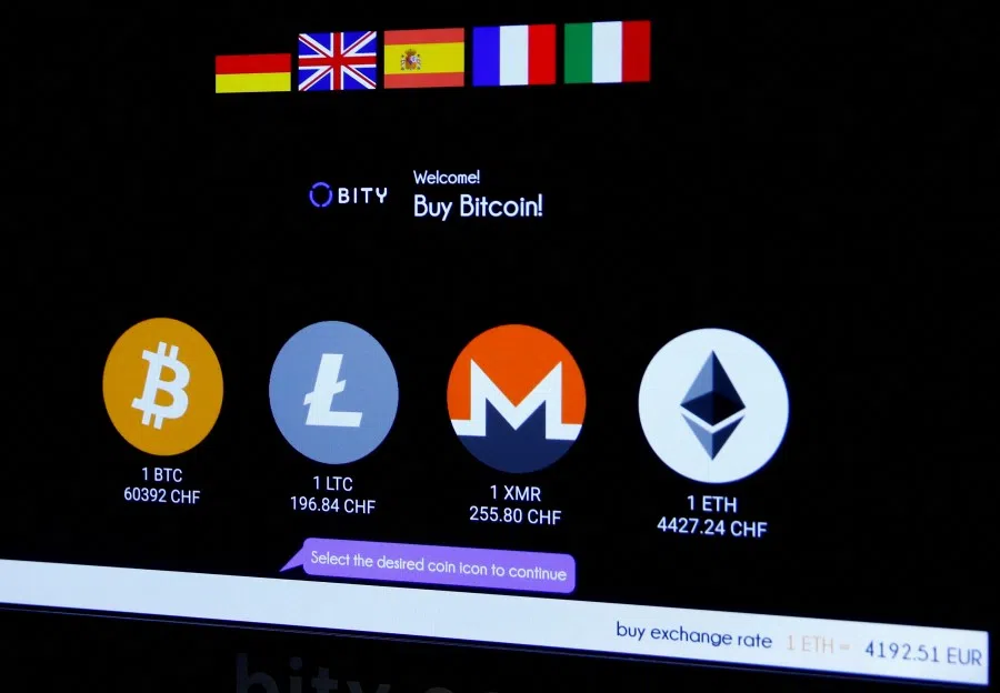 The logos and exchange rates of Bitcoin (BTH), Litecoin (LTC), Monero (XMR) and Ether (ETH) to Swiss franc (CHF) are seen on the display of a cryptocurrency ATM of blockchain payment service provider Bity at the House of Satoshi bitcoin and blockchain shop in Zurich, Switzerland, on 4 November 2021. (Arnd Wiegmann/Reuters)