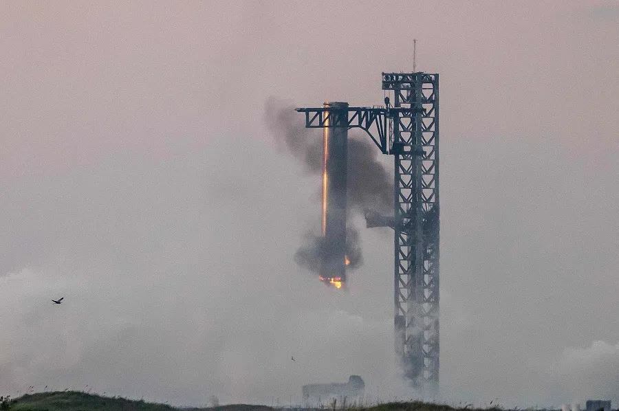 Starship’s Super Heavy Booster is grappled at the launch pad in Starbase near Boca Chica, Texas, on 13 October 2024, during the Starship Flight 5 test. SpaceX successfully “caught” the first-stage booster of its Starship megarocket Sunday as it returned to the launch pad after a test flight, a world first in the company’s quest for rapid reusability. (Sergio Flores/AFP)