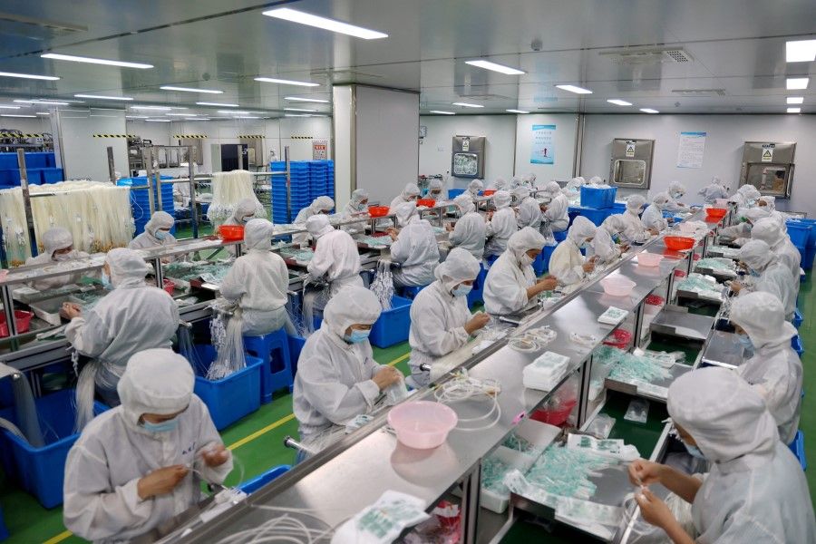 Workers produce medical supplies that will be exported at a factory in Binzhou, in China's eastern Shandong province, on 15 June 2023. (AFP)