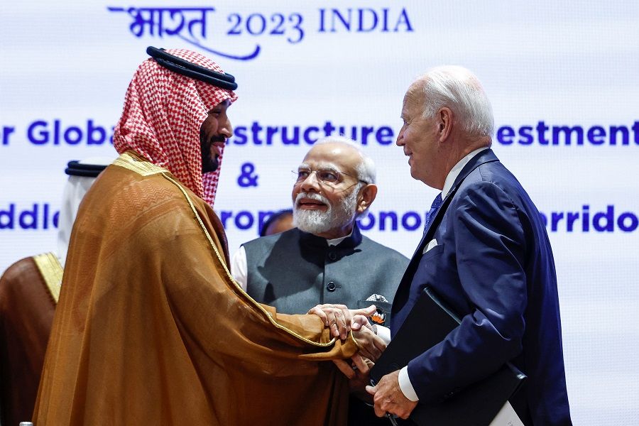 Saudi Arabian Crown Prince Mohammed bin Salman Al Saud and US President Joe Biden shake hands next to Indian Prime Minister Narendra Modi on the day of the G20 summit in New Delhi, India, 9 September 2023. (Evelyn Hockstein/Pool/Reuters)