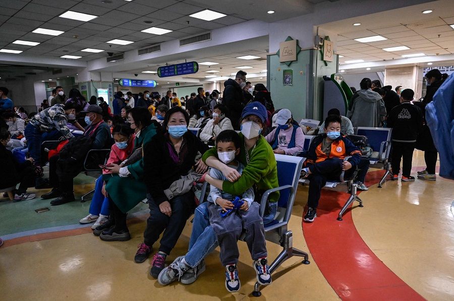 Children and their parents wait at an outpatient area at a children's hospital in Beijing, China, on 23 November 2023. (Jade Gao/AFP)